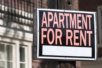 close-up of a sign in front an apartment building