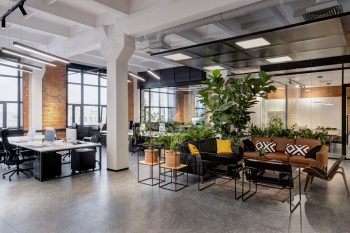 modern loft office interior with panoramic windows and a row of dark wood tables