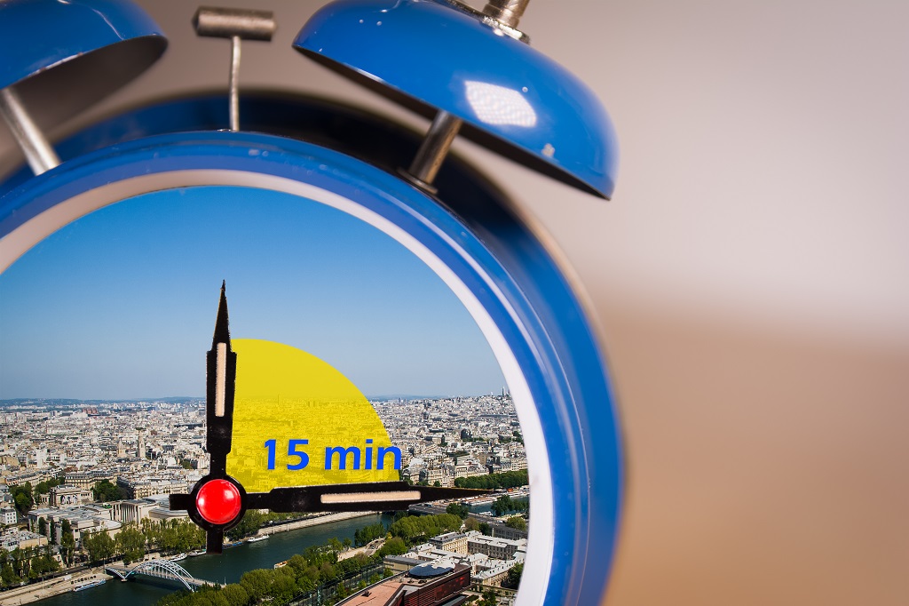 15-minute city concept inside a ringing twin bell vintage classic alarm clock. A 15-minute city is a residential urban concept in which most daily necessities can be accomplished by either walking or cycling from residents' homes