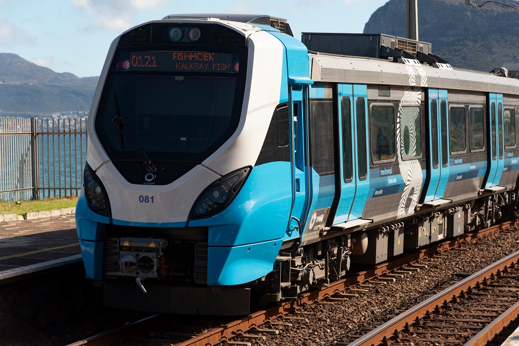 St James station, Western Cape, South Africa. 2023. A new blue train the People's Train departs St James station on the coastal route to Fish Hoek Cape Town.