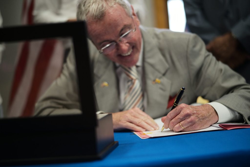 Governor Phil Murphy signing a law.