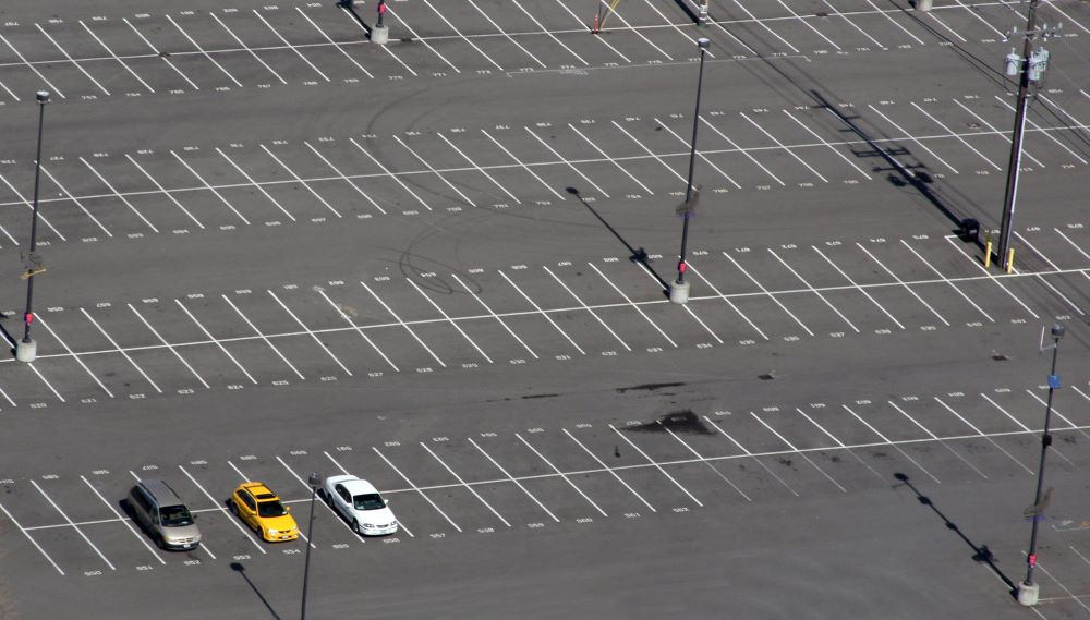 A mostly empty large parking lot.