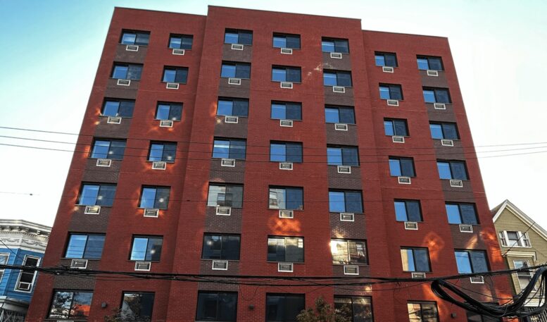 The new development, a large multistory brick building.