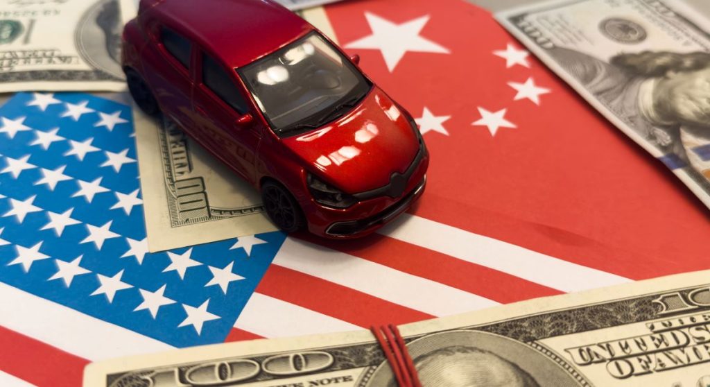 A car driving on an American flag surrounded by 100 dollar bills.