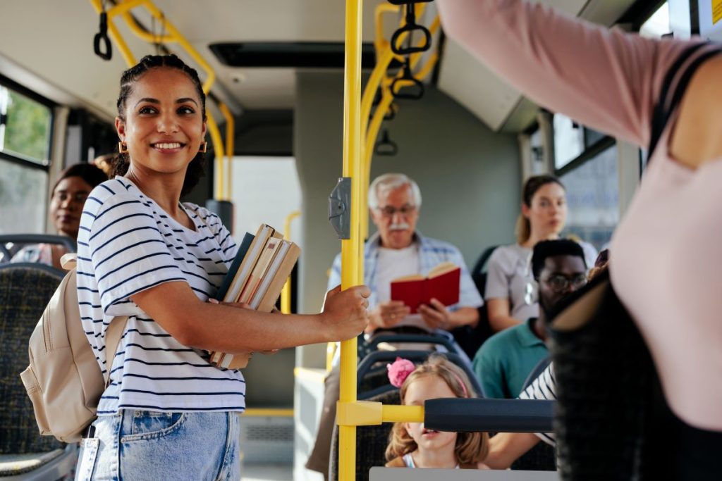 A woman and others commuting via a bus. 