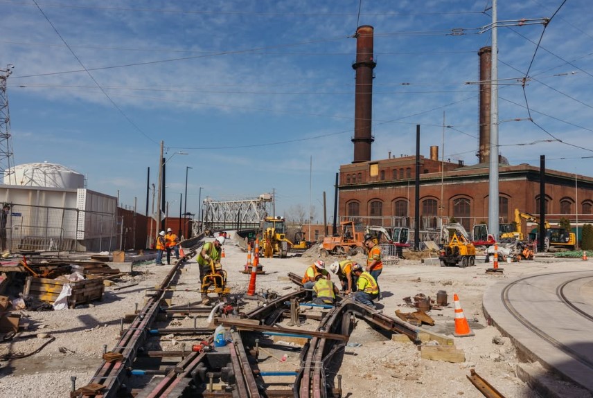 Construction workers installing rail lines for the KC Streetcar Riverfront Line extension.