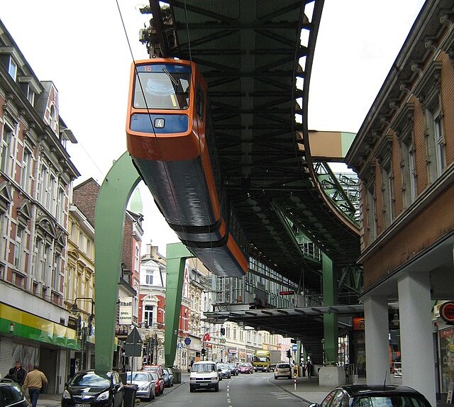 The Wuppertal Schwebebahn suspended above a road.
