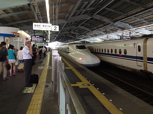 Passengers waiting to board high-speed rail in Japan.