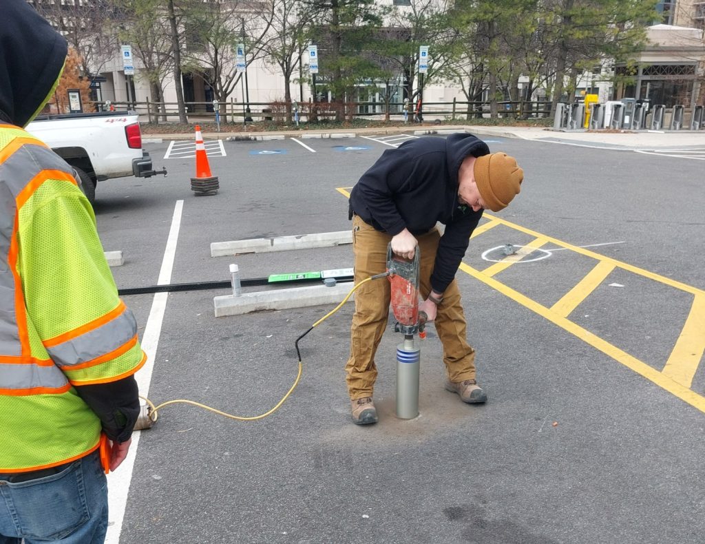 Installing sensors to measure parking space occupancy.