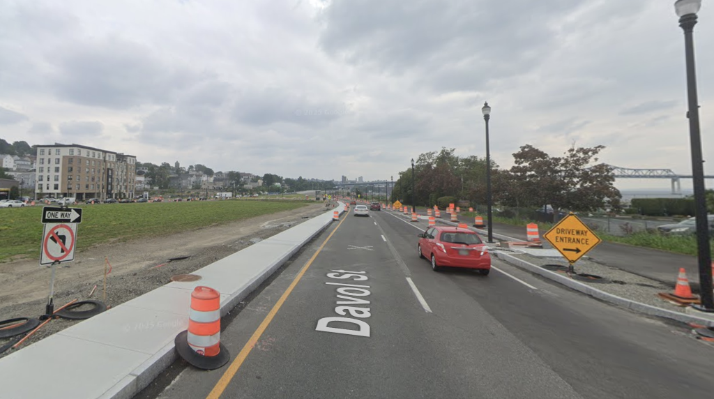 Land available for redevelopment (left) alongside protected bike lanes (right). Google Street View.