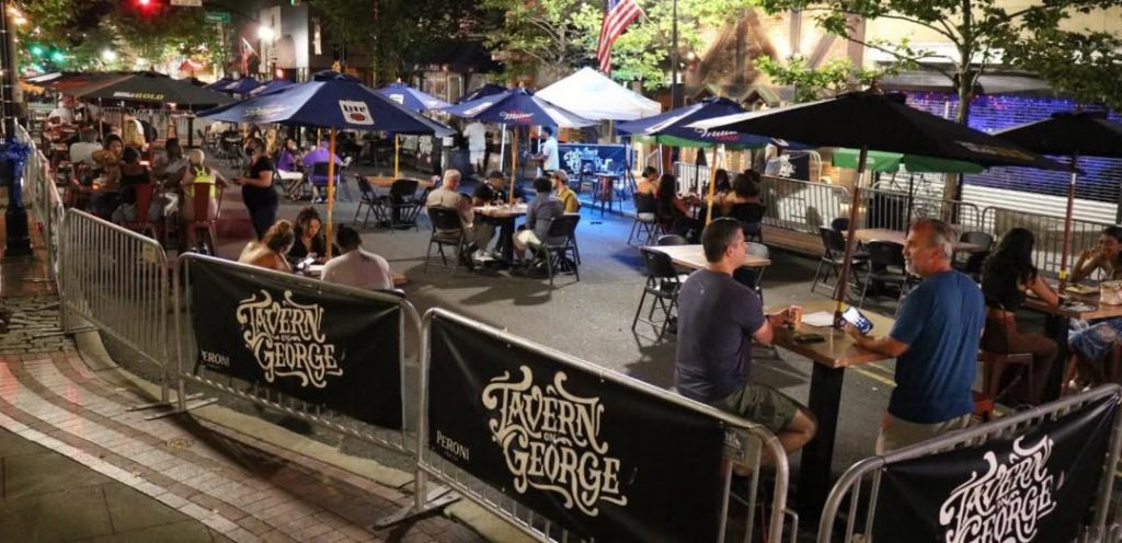 Busy pedestrian plaza on George Street during night