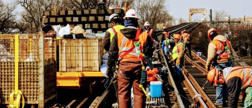 A team of construction workers work on a railway