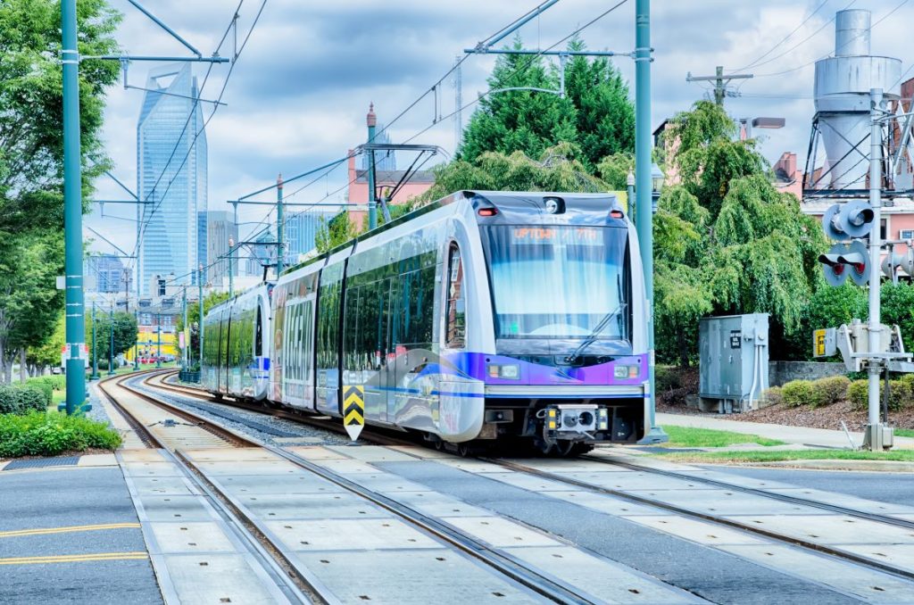 Light rail train with the Charlotte skyline in the background