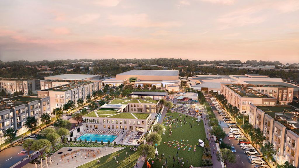 Rendering of Monmouth Square. The rendering shows a large green public space surrounded by housing and commercial spaces