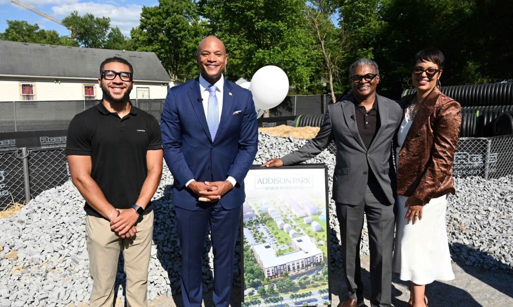 Governor Wes Moore and other officials standing in front of a construction site.
