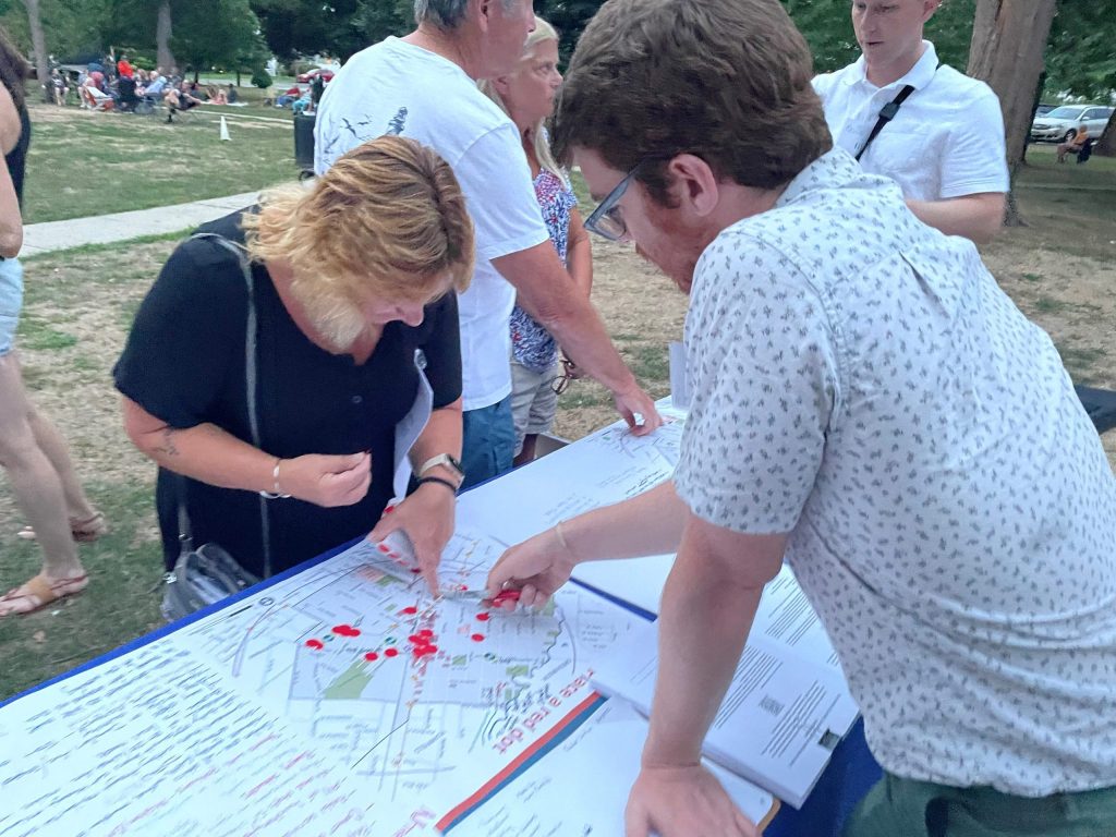 TFP Program and NV5 team assists a resident at the NJ TRANSIT table during the Music in the Park event. Courtesy of Jared Aisenberg