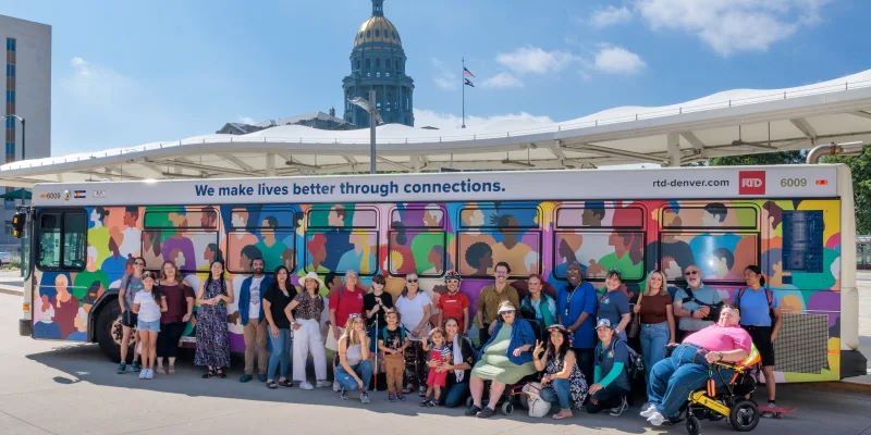Transit Equity Office at RTD-Denver. The staff are posing in front of a bus.