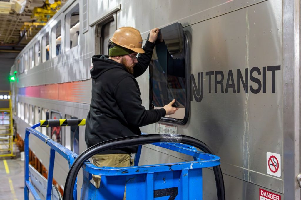 NJ TRANSIT worker repairing a train