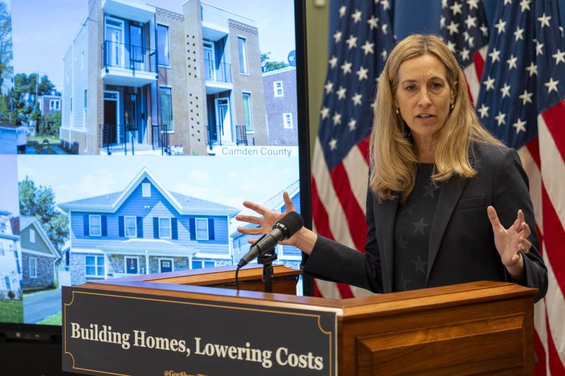 Governor Sherrill in front of a podium that says, "Building Homes, Lowering Costs"
