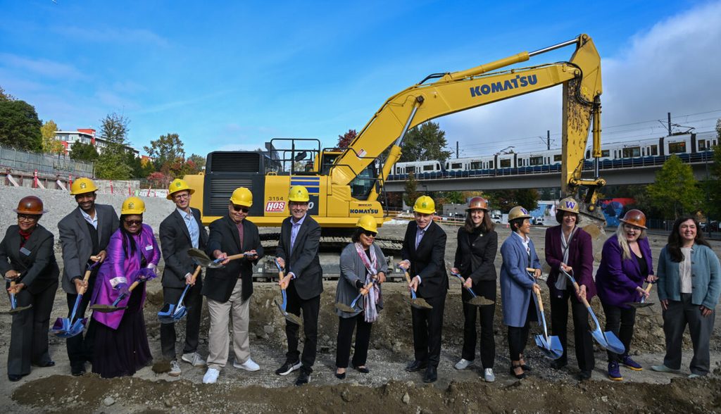Group of people holding shovels on a construction site