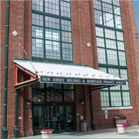 Brick building with an awning reading "New Jersey Housing & Mortgage Finance Agency"
