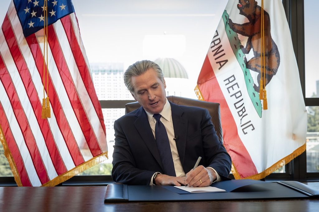 California Governor Gavin Newsom signing a bill.